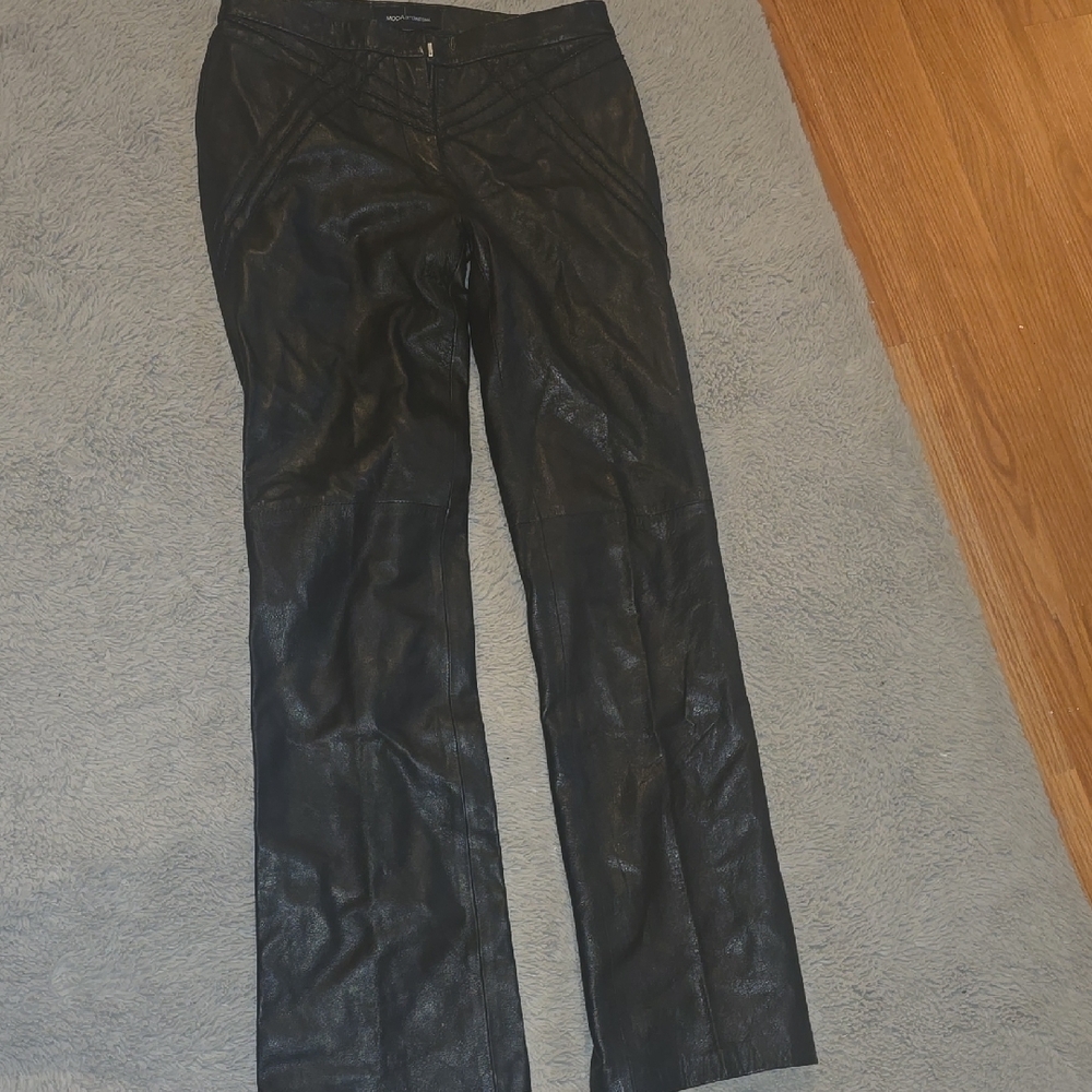 Moda international black leather pants boot leg.  Small stain on side took oi
